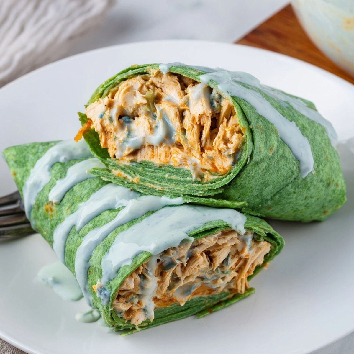 Spicy Buffalo Chicken Wraps oozing with blue cheese, ready for a quick lunch.
