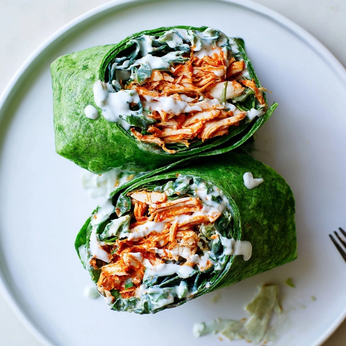 Easy Buffalo Chicken Wraps recipe: a vibrant, handheld lunch with creamy dressing.