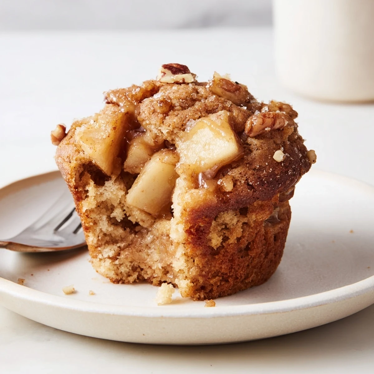 Golden-brown caramel apple chunk muffins warm from the oven, ideal for cozy snacking.