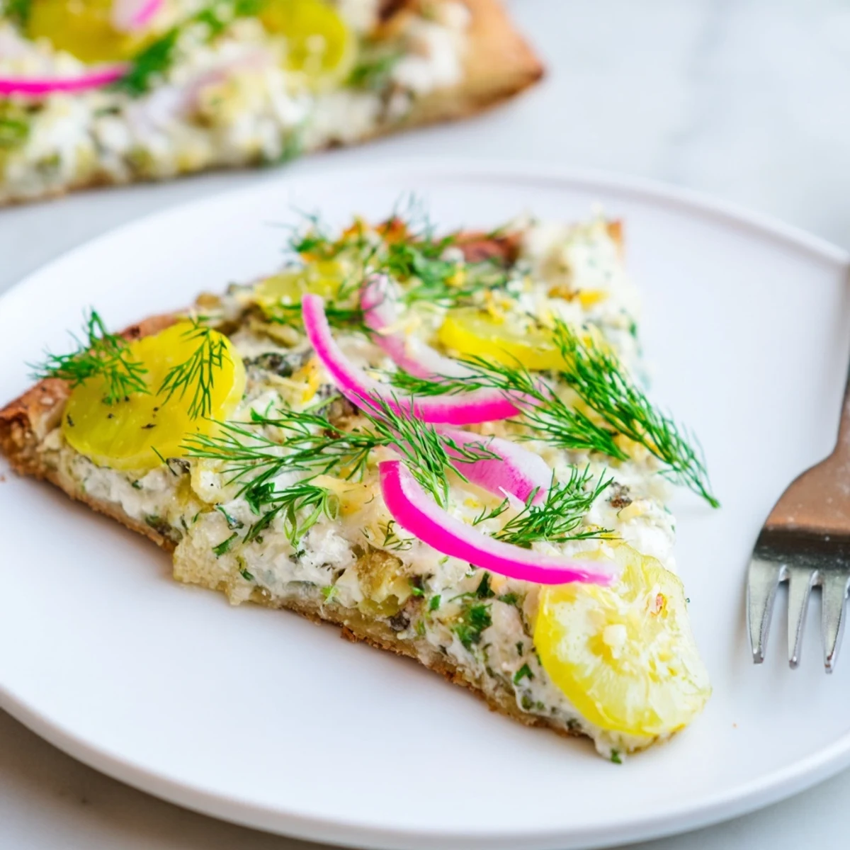 Creamy pickle pizza topped with mozzarella and crunchy pickles, perfect for adventurous eaters.  