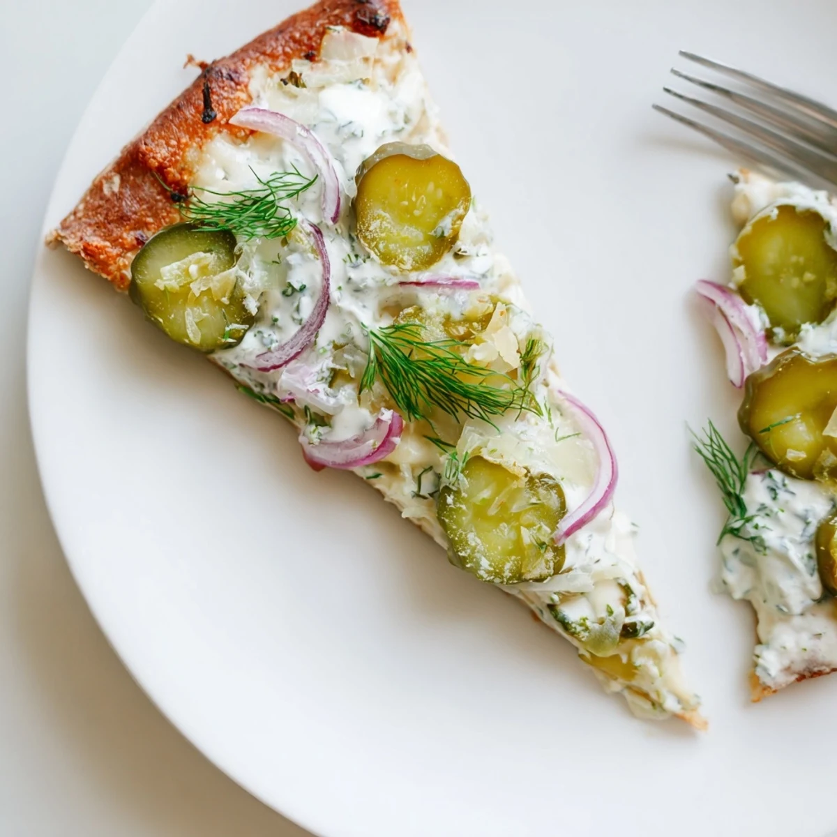 Sizzling hot pickle pizza emerges from the oven, bursting with tangy crème fraîche flavor.  