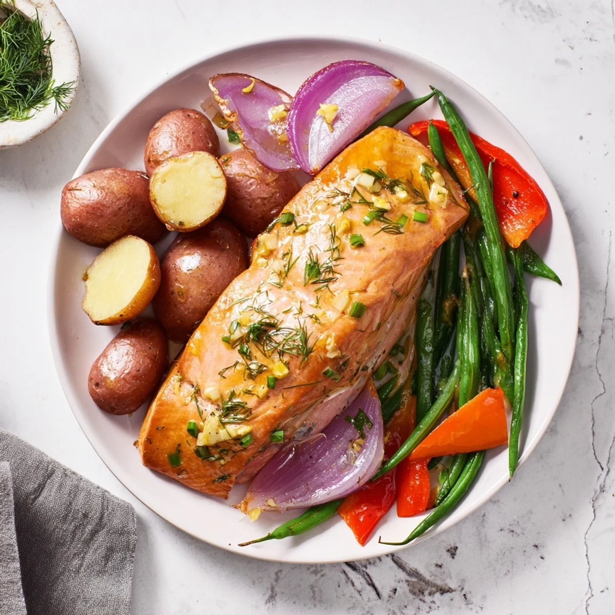 Tender, marinated salmon fillets perfectly baked with potatoes in this amazing Lemon Herb Salmon & Potato Sheet Pan.