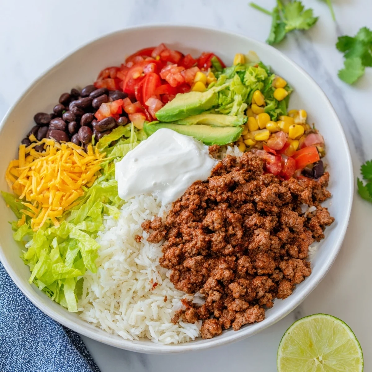 Savory loaded beef burrito bowl, a layered delight showing seasoned beef and fresh toppings.