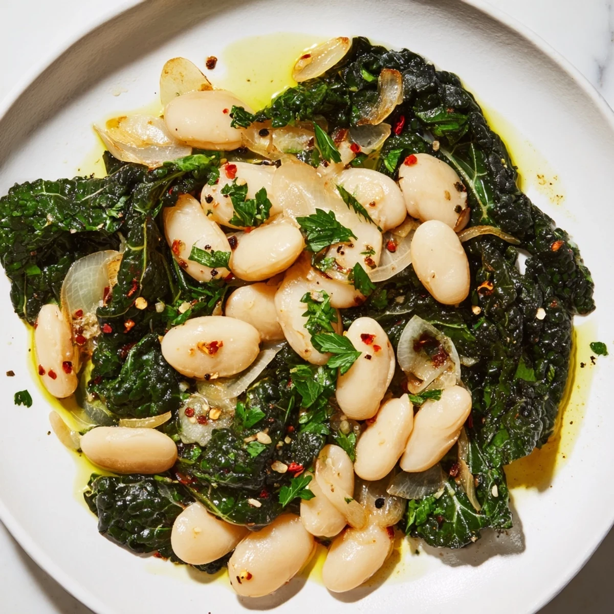 Hearty garlicky beans with winter greens, showcasing textures: creamy beans and tender greens.