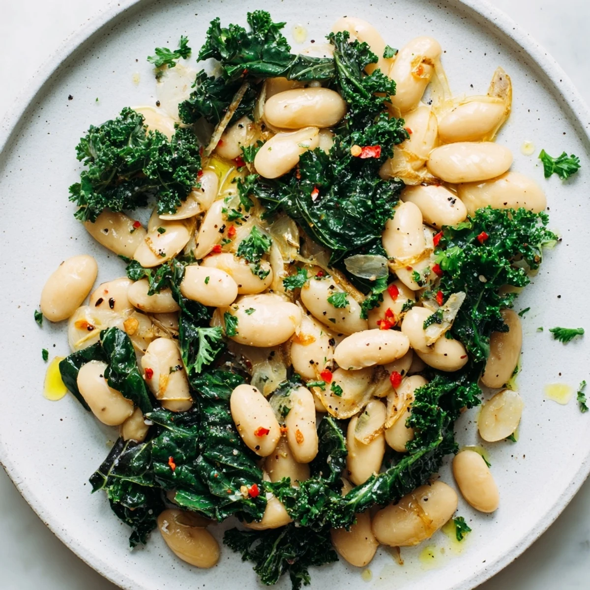 Fragrant, garlicky beans with winter greens, a delicious vegetarian dish, ready to serve warm.