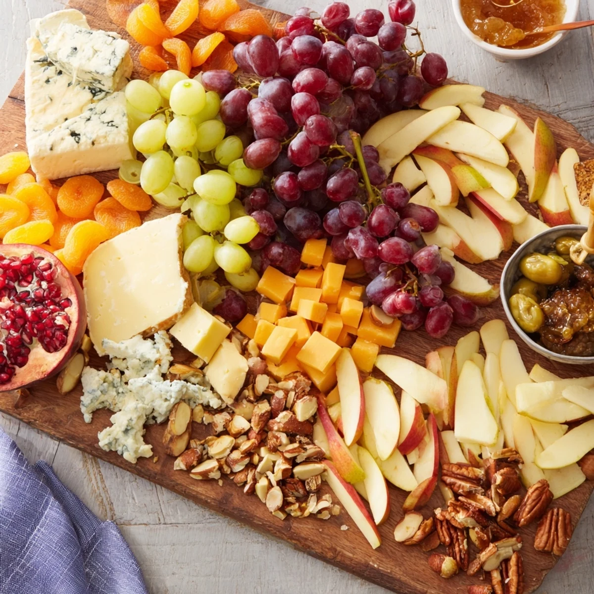 Vibrant Cornucopia Harvest Board overflowing with colorful fruits, cheeses, meats, and crunchy nuts.