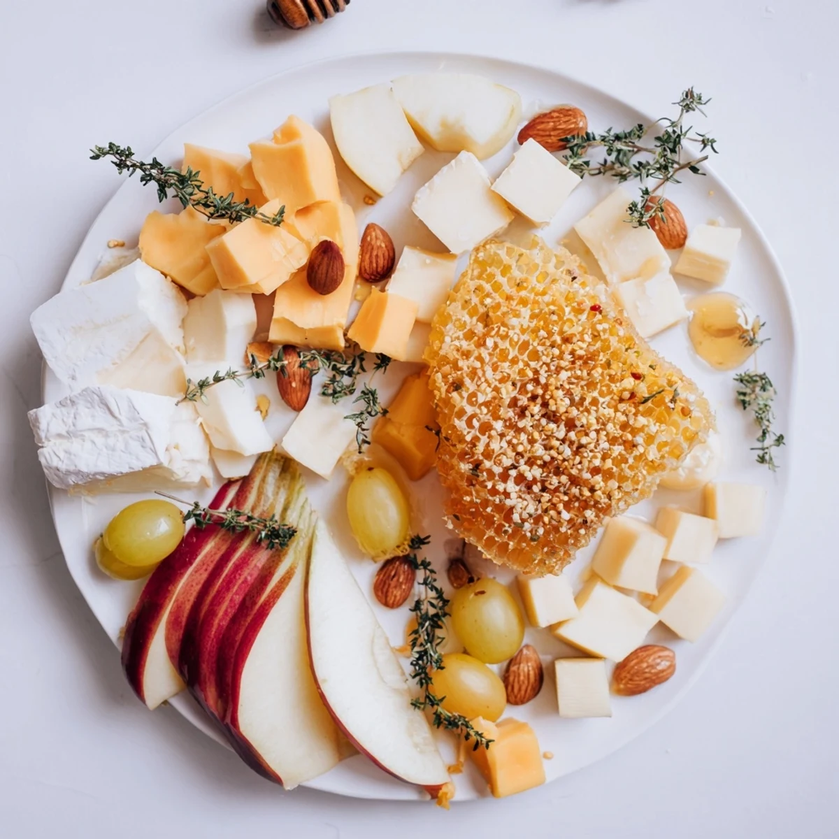 This colorful Busy Bee Honeycomb Snack Plate features an array of cheeses, crackers, and sweet honey.