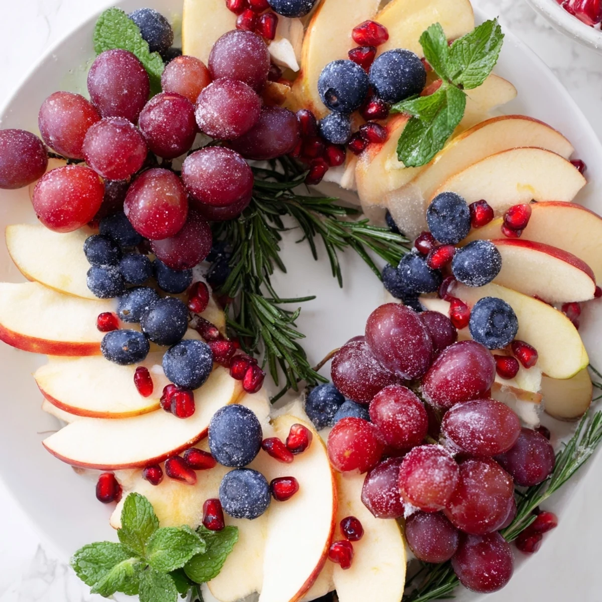 Vibrant winter berry wreath fruit board, a colorful holiday appetizer of fresh berries and kiwi slices.