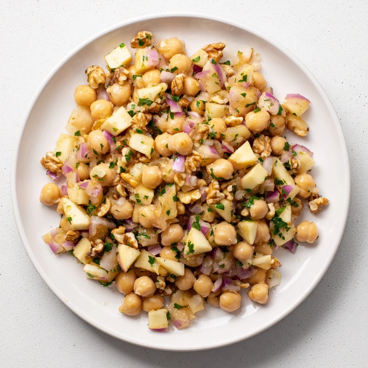 Fall Harvest Apple and Chickpea Salad: a colorful combination of apples, chickpeas, and walnuts, ready to enjoy.