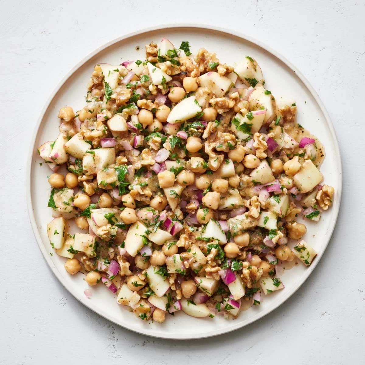 This vibrant Fall Harvest Apple and Chickpea Salad shows off crunchy walnuts and a sweet honey-mustard dressing.