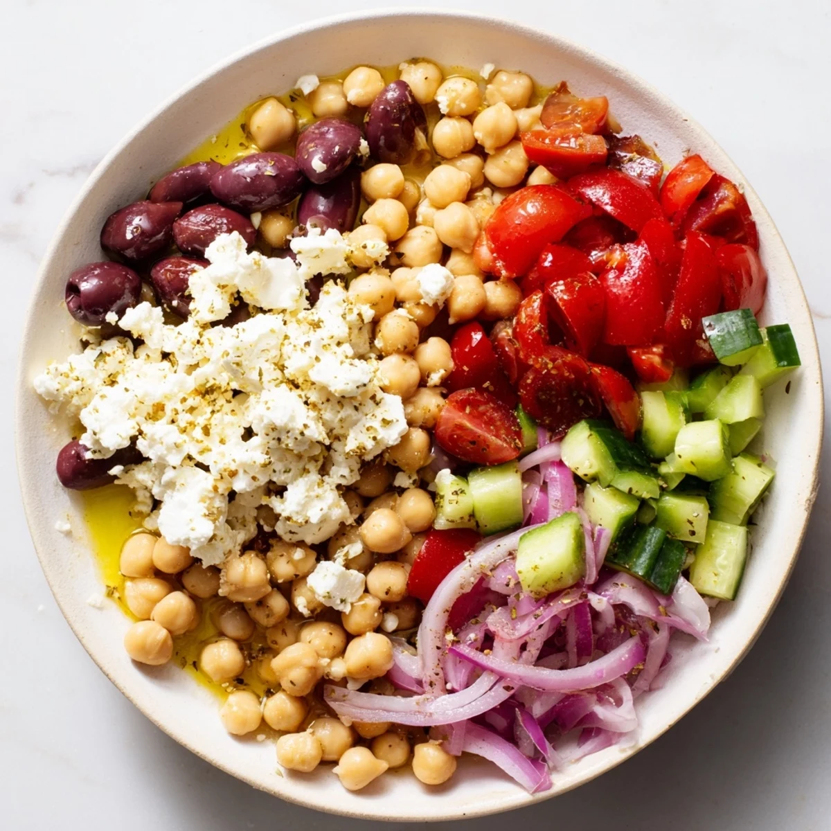 This colorful Mediterranean Chickpea and Feta Bowl looks so delicious, ready to eat with a perfect dressing swirl.