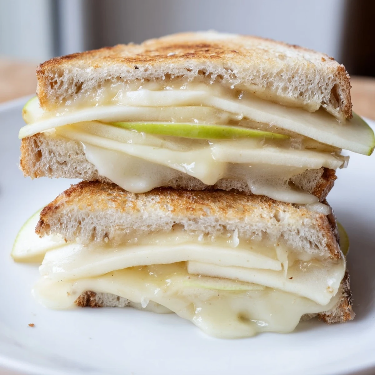 Golden Brie and Apple Grilled Cheese, melty and crisp, with apple slices in sourdough.