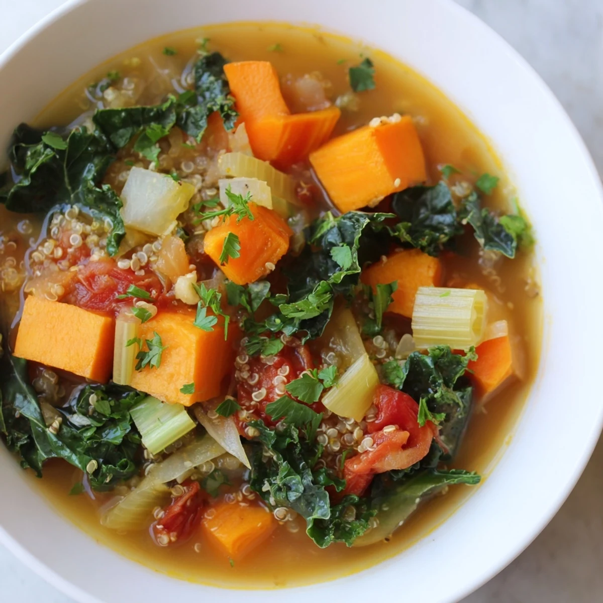 This vibrant Nourishing Winter Veggie Soup brimming with colorful vegetables and hearty quinoa, ready to eat.