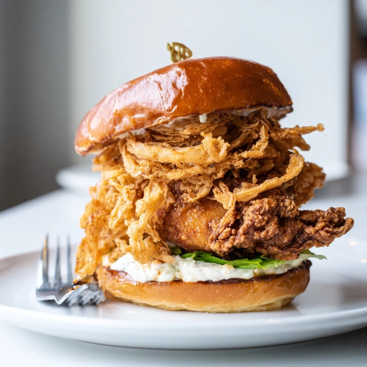 Homemade Crispy Onion Chicken Sandwich with golden chicken thighs and crunchy onion topping.