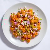 This colorful buffalo chicken bean salad features juicy chickpeas, crunchy vegetables, and zesty sauce.