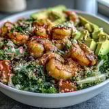 Colorful Rainbow Vegetable Detox Bowl featuring crisp blanched broccoli and asparagus, vibrant red cabbage, and diced tomatoes alongside tender shrimp.