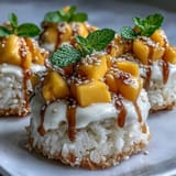 Sweet coconut mango sticky rice cups topped with fresh, juicy diced mangoes and seeds.