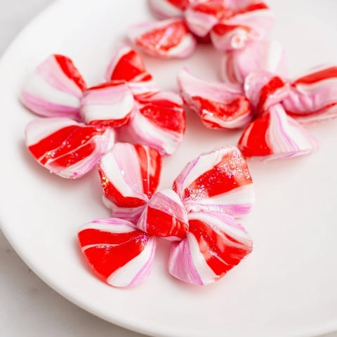 Glistening, finished Express Peppermint Candy Bows, ready to be arranged on a dessert or enjoyed right away.