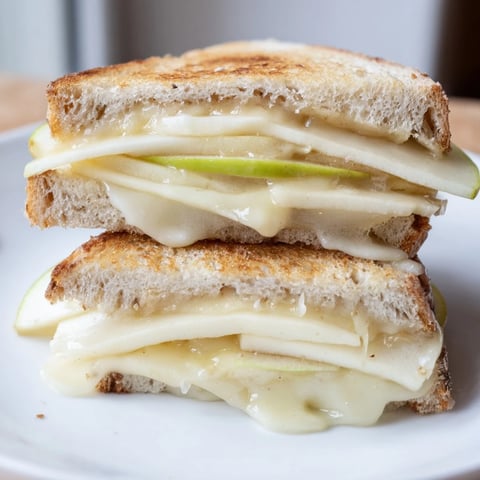 Golden Brie and Apple Grilled Cheese, melty and crisp, with apple slices in sourdough.