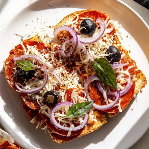 Golden, bubbly Pizza Toast 2.0 with melting mozzarella, perfect for a quick and satisfying snack.