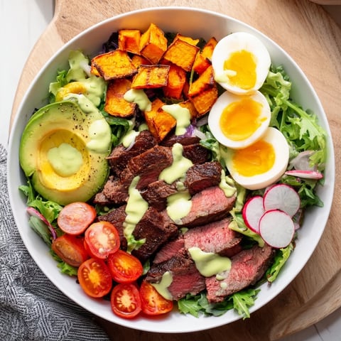 A colorful High-Protein Beef Avocado Bowl, featuring seared beef, fresh avocado, and a perfect egg.