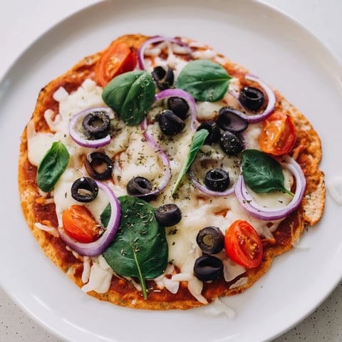 Crispy Tortilla Pizza with melted cheese, fresh toppings, and a golden, crunchy crust.