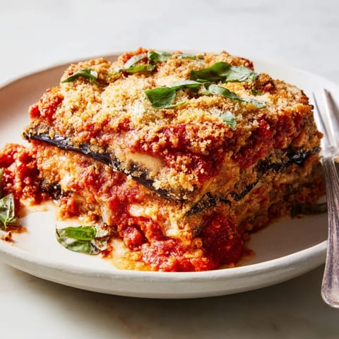 Warm Eggplant Parmesan Lasagna served with melted mozzarella and fresh basil on top.  