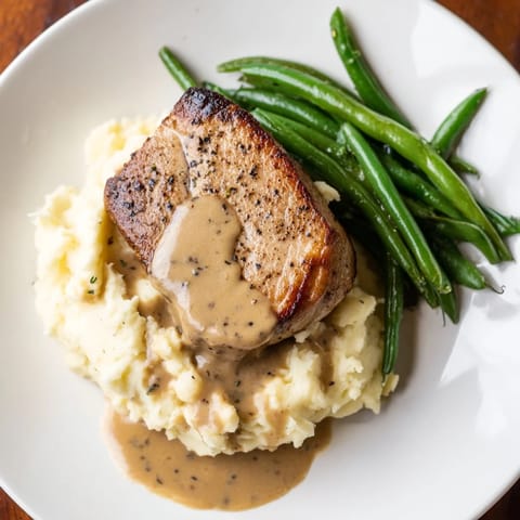 A close-up of delicious Pork Chops & Cheddar Mash Bowl, a satisfying American dinner.