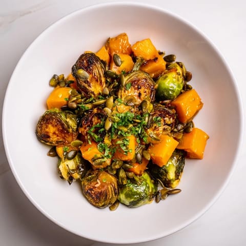 Buttery roasted butternut squash and Brussels sprouts coated in vibrant, citrus orange dressing, so delicious.