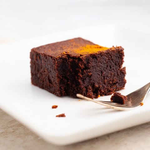 Warm, freshly baked Pumpkin Workout Brownies with a slightly cracked top, perfect for a healthy dessert.