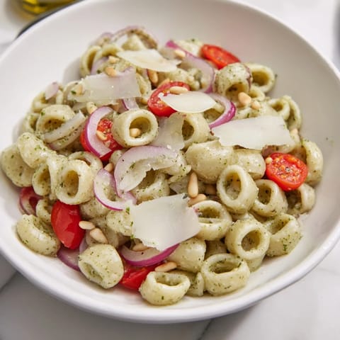 This vibrant Caesar Pesto Ditalini Salad boasts creamy pesto dressing over ditalini pasta with crunchy vegetables.