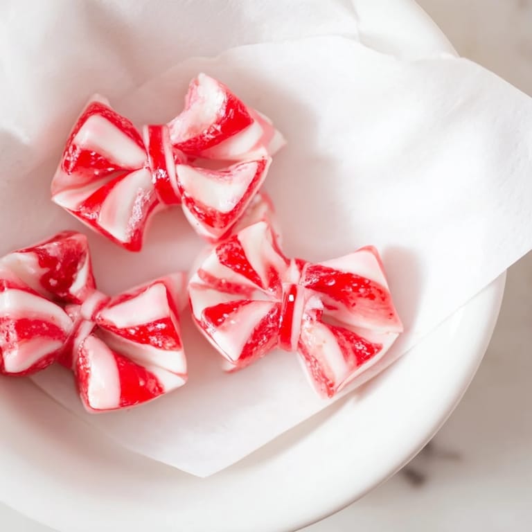 Hot, melty Express Peppermint Candy Bows shimmering with edible glitter, ready for gifting or holiday treats.