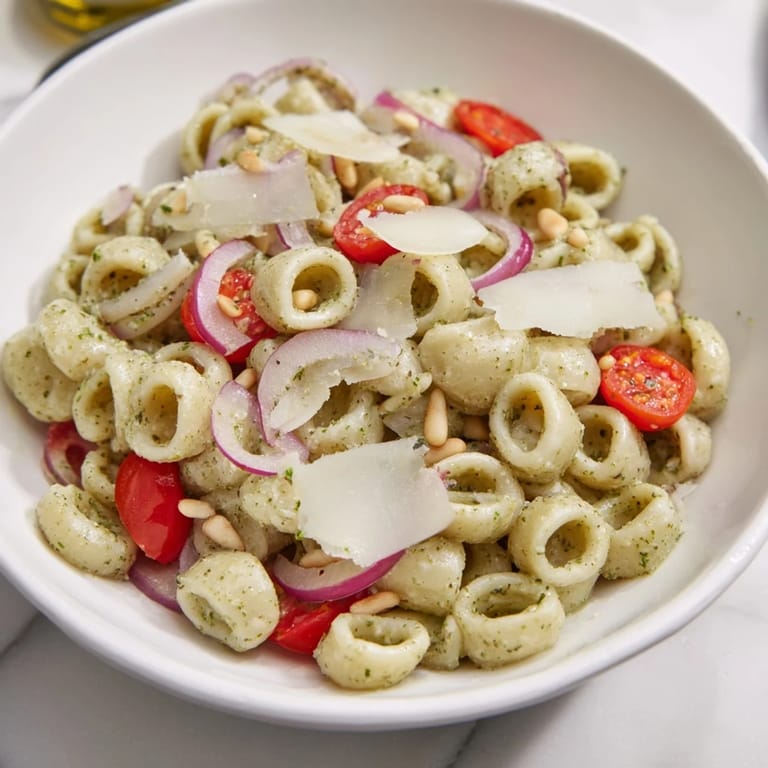 This vibrant Caesar Pesto Ditalini Salad boasts creamy pesto dressing over ditalini pasta with crunchy vegetables.