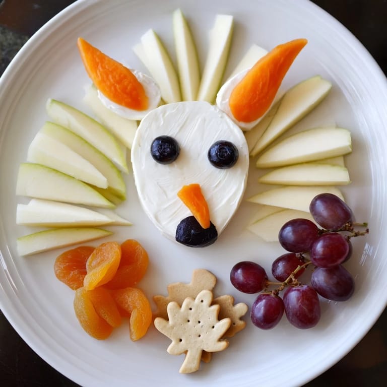 Vibrant, festive Whimsical Fox Fall Treat Board showcases a charming fox goat cheese face with assorted snacks.