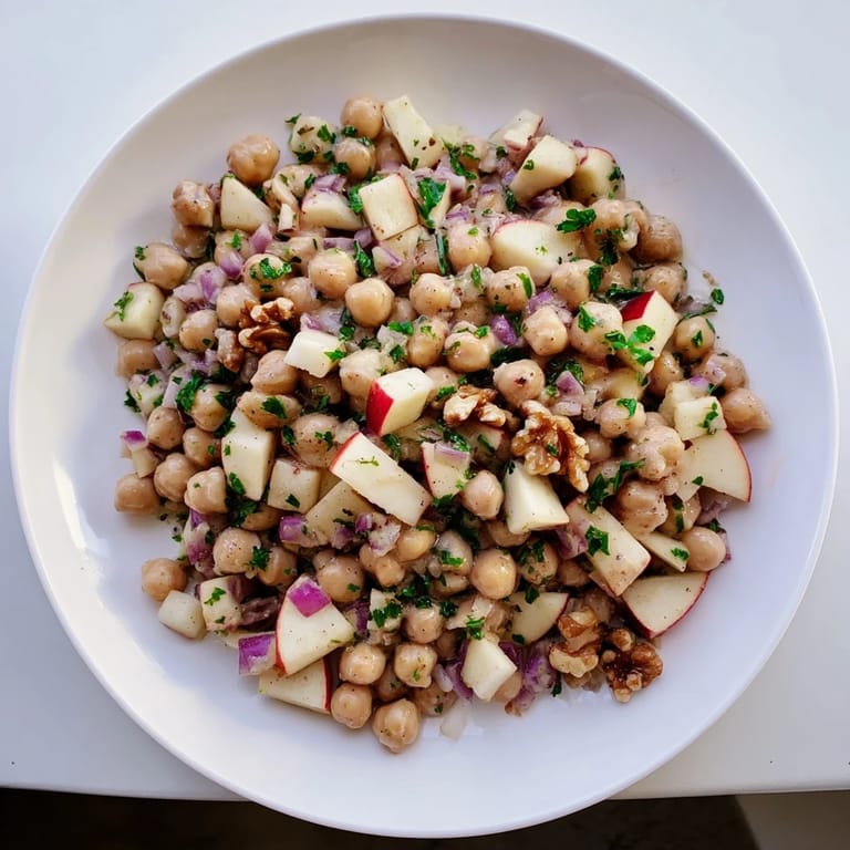 Freshly tossed Fall Harvest Apple and Chickpea Salad featuring crisp apple pieces and a creamy dressing, delicious!