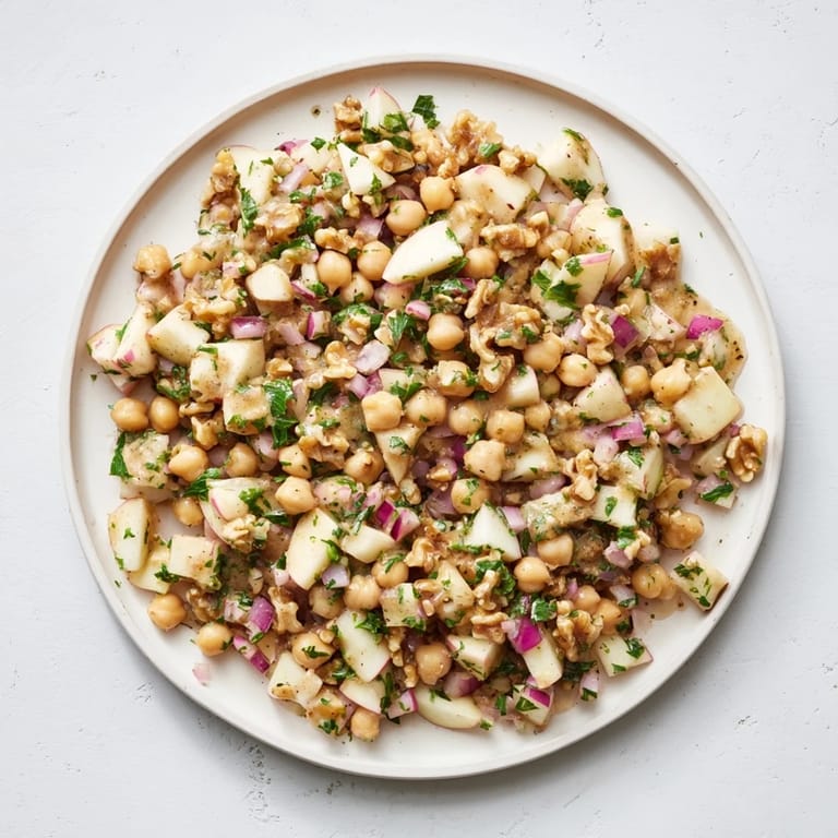 This vibrant Fall Harvest Apple and Chickpea Salad shows off crunchy walnuts and a sweet honey-mustard dressing.