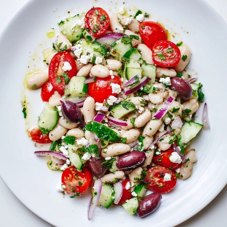 A bowl of fresh white bean salad, perfect for a light lunch or a delightful side.
