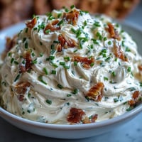 1. Creamy garlic cream cheese spread with roasted garlic cloves, whipped until light and fluffy, perfect for bagels or crackers.  